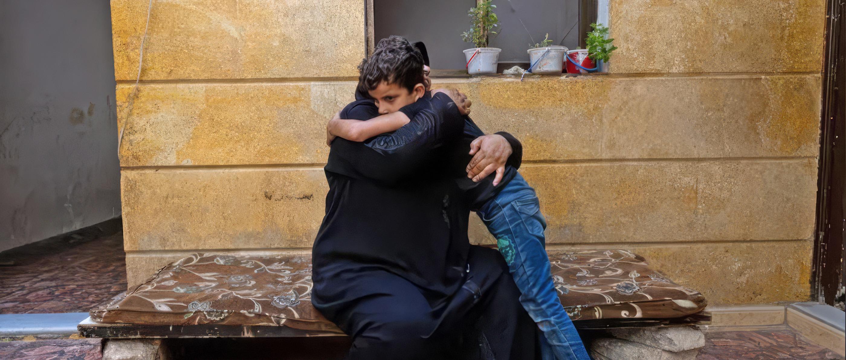 Eine Frau und ein Junge umarmen sich